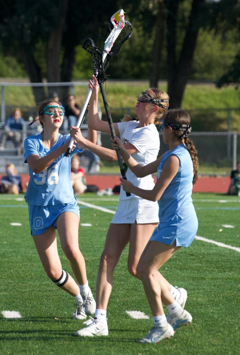 Faith Witte (10) catches the ball in the air through the other teams defense. The Rio Americano girls lacrosse team defeated Oakmont 10-7 at home on March 26, 2025. 