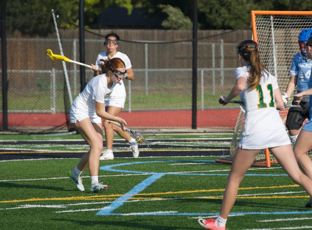 Bailey Bartlett (11) scoops up a rouge groundball. The Rio Americano girls lacrosse team defeated Oakmont 10-7 at home on March 26, 2025. 