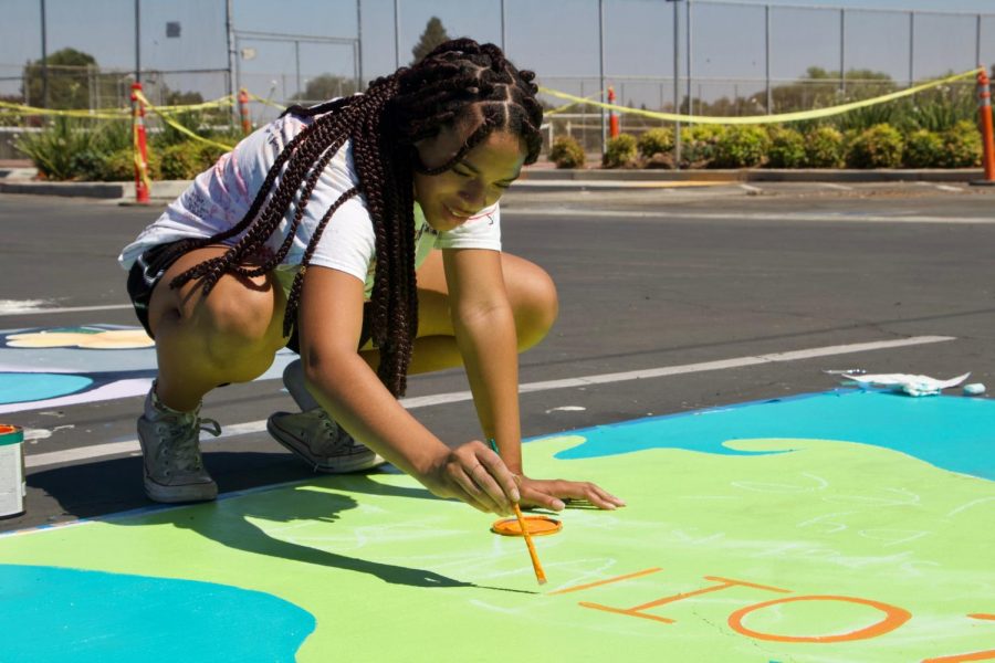 Senior Ajee Brooks paints the Mystery Machine from Scooby Doo on her spot with the phrase “Zoinks this spot is taken by Ajee”. The design matched her keychain and is a catch-phrase she uses.